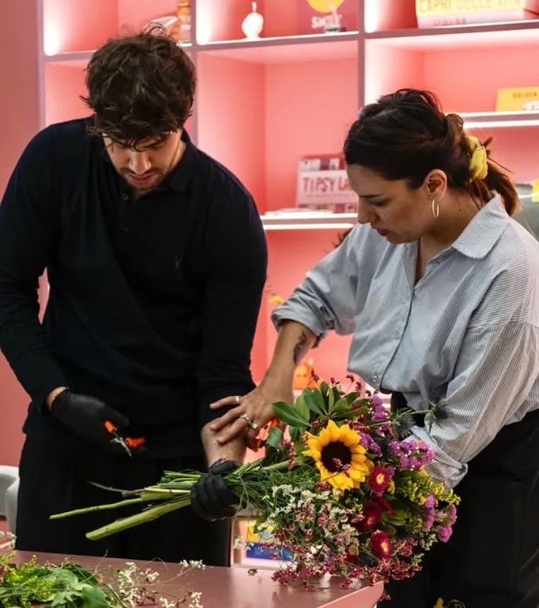 A student and instructor working together on a flower making project